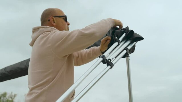 Man Installing Boat Bimini Top