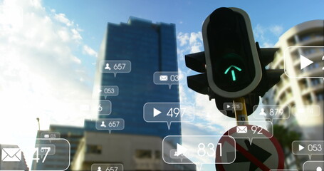 Image of notification icons with numbers over traffic signal changing lights in city