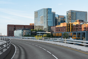 Empty urban asphalt road exterior with city buildings background. New modern highway concrete construction. Concept of way to success. Transportation logistic industry fast delivery. Boston. USA.
