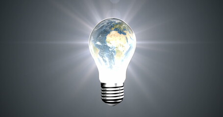 Image of circuit board pattern and globe in illuminated light bulb against abstract background