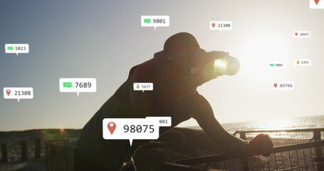 Fototapeta premium Image of notification icons and changing numbers, thirsty african american man drinking water