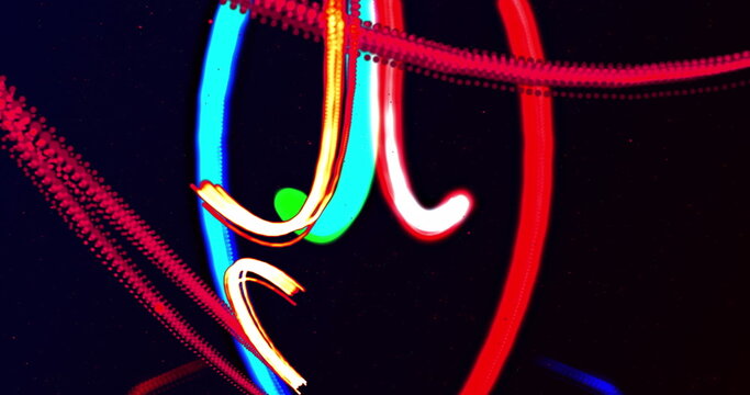 Image of blue, green and red light trails moving on black background - Powered by Adobe
