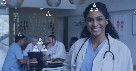 Image of media icons over diverse doctors talking - Powered by Adobe