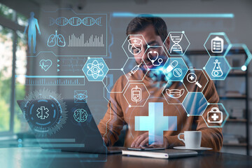 Thoughtful businessman in casual wear typing on laptop at office workplace. Concept of insurance company, help, business, internet surfing, information technology. Medical icons hologram