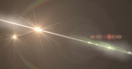 Image of yellow glowing light moving on brown background
