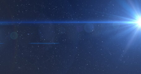 Image of blue glowing light moving over stars on blue background