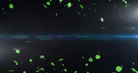 Image of light spots and clovers over black background