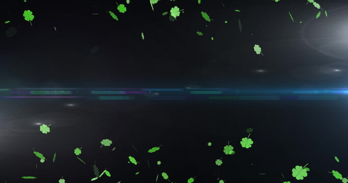 Image of light spots and clovers over black background - Powered by Adobe