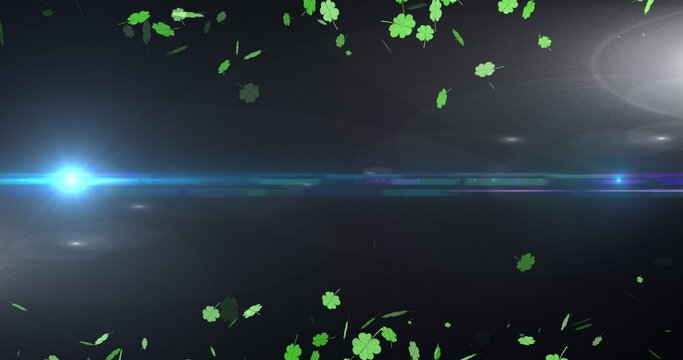 Image of light spots and clovers over black background - Powered by Adobe