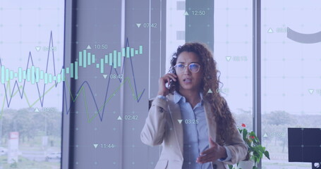 Image of financial data processing over biracial businesswoman talking on smartphone