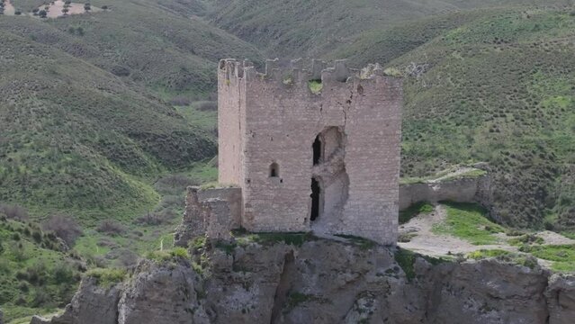 flight in reverse visualizing the castle of Oreja 9th century we see a deterioration in the tower, moving away we contemplate the spectacular situation of the castle in ravines Ontigola Toledo Spain