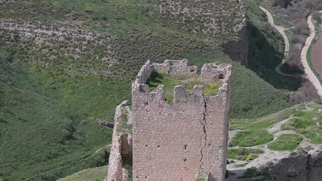 orbital flight with a drone over the 9th century Oreja castle, creating a spectacular visual effect by filming in 70mm with a background of wild fields and a magnificent location of the fortress