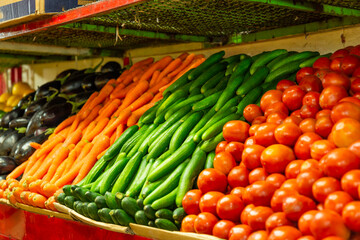 Fresh cucumbers, tomato and carrots,  on a daily market 