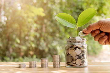 Coins in a clear glass jar money saving concept