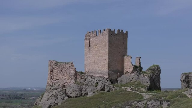 reverse flight in the castle of Oreja 9th century in the foreground the keep and remains of the wall with a background of blue sky we see the magnificent location of the Ontigola fortress Spain