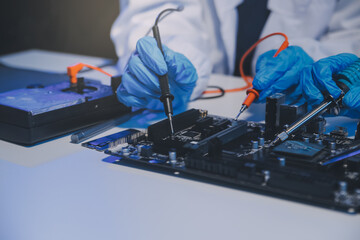 Naklejka premium Close up of Technician measuring voltage electronic circuit board television, Service after sale fix electric equipment within insurance.
