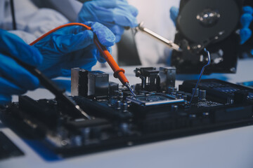 Naklejka premium Close up of Technician measuring voltage electronic circuit board television, Service after sale fix electric equipment within insurance.