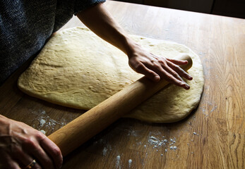 rolling out dough for homemade cinnamon rolls 