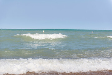Beach near Lake Michigan. Rough waves. Two waves on the water.