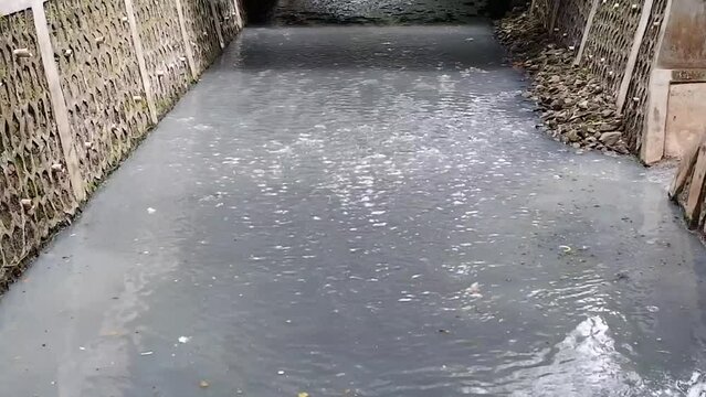 The river flow is polluted with various kinds of dirty materials