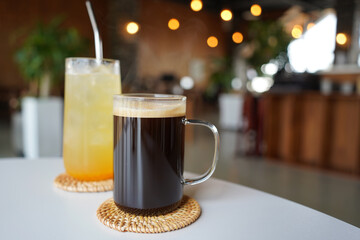 Warm coffee and cool orange juice are served in a cafe with a nice atmosphere.