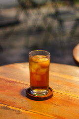 a glass of iced lychee tea on the table