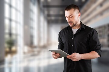 Portrait of a young businessman standing in modern office