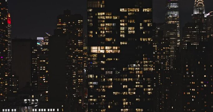 NYC New York Aerial v171 low tracking shot drone flyover capturing night cityscape of Midtown Manhattan, illuminated skyscrapers with shimmering glass facade - Shot with Inspire 3 8k - September 2023