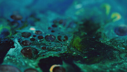 Paint bubbles. Oil fluid. Ink mix. Defocused blue green black color glitter foam texture emulsion...