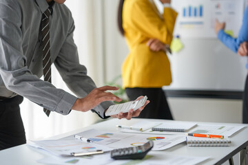 Close-up of business people meeting together to present a new project plan, analysis, marketing...