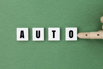 white square with the word auto. an informal, shortened form of automobile.