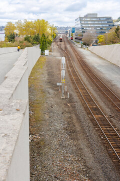 Railway tracks receding through an urban corridor in Seattle, Washington