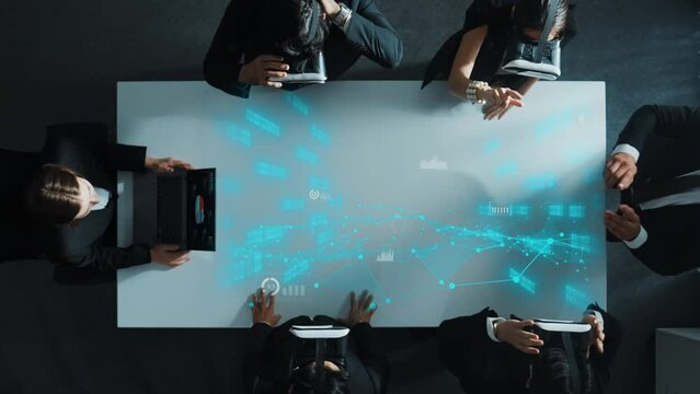 Project manager using laptop send data analysis while smart business team wear vr and working in metaverse or virtual program with hologram of marketing statistic or financial startegy. Directorate.