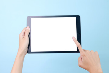 Hands holding digital black tablet for mockup isolated on blue background