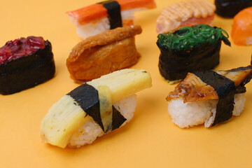 Assorted Sashimi Sushi Roll on Yellow Background.