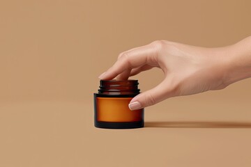 Female hand touching unbranded amber glass jar with face mousturizing cream. Bottle for professional cosmetics product. Skincare and beauty concept. Mockup