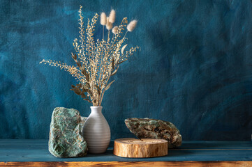 Dried branches of flowers in a vase, green stones amazonite, cross section of tree trunk as a...