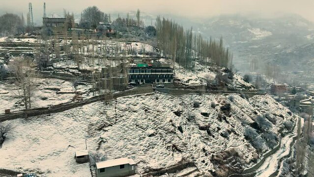 Aerial View Of Snow Covered Karimabad In Hunza Valley. Push Forward Shot