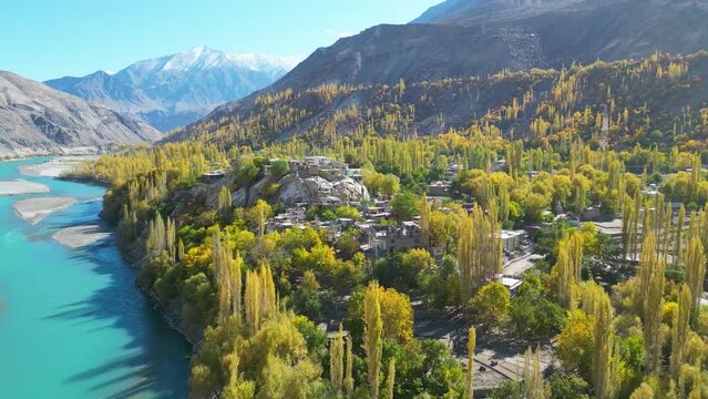 Drone flight over the valley with green trees and a river in skardu city  