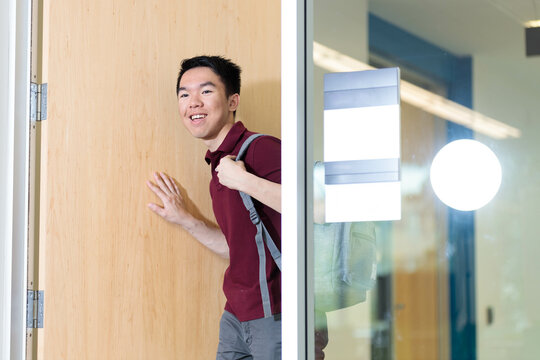 A student is walking into the classroom through the door