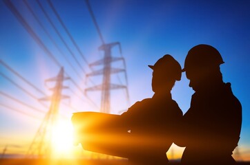 Colleagues shake hands. power engineers and power lines background