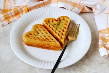 Heart shape of Plain Croissant Waffle or Croffle served in white plate