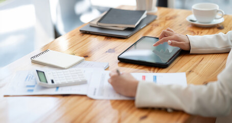 Closeup business woman hand using digital tablet at office.