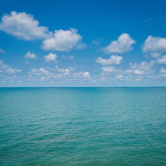Fototapeta premium Blue sea or ocean with sky and white clouds