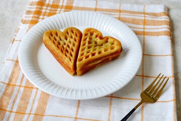 Heart shape of Plain Croissant Waffle or Croffle served in white plate
