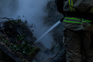 Firefighter at Work. grass and rubbish burns
