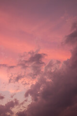 The sky is painted with vivid pink and purple hues, marking the canvas of a stormy, cloudy sunset....
