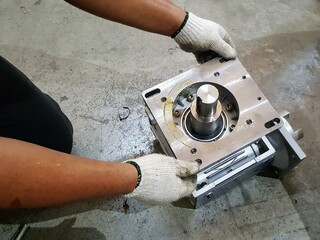 a photography of a person working on a machine in a garage.