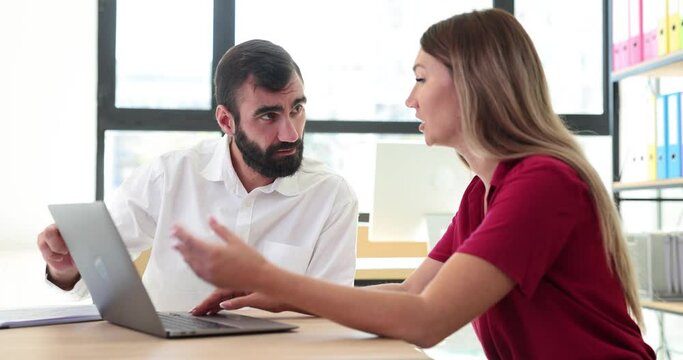 Confident businessmen discussing project details and finalizing agreement with handshake