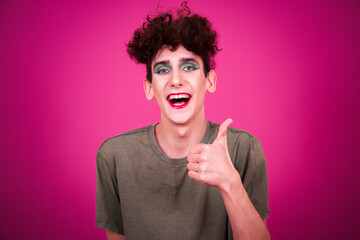 A funny guy in make-up is doing fitness. retro style. Pink background.